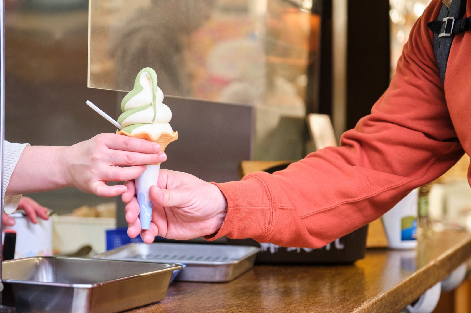 european-tourist-buying-matcha-ice-cream-at-a-kios-2023-11-27-05-16-58-utc